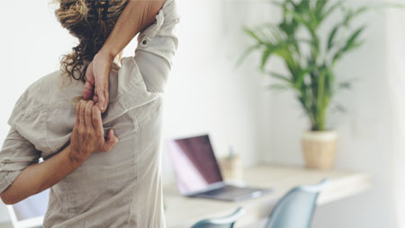woman with backpain in the office